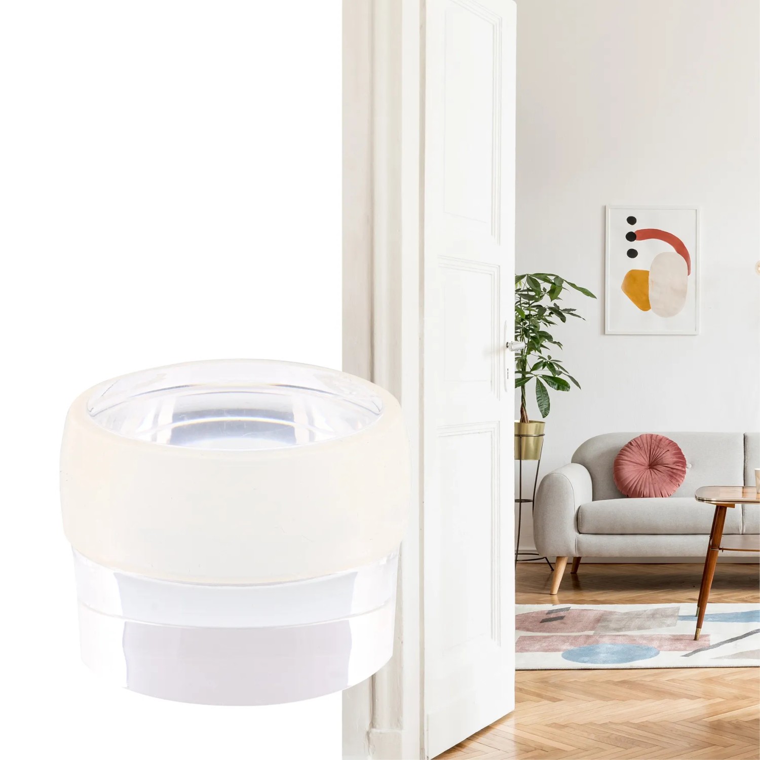 Transparenter Wagner Bodentürstopper Clear (Ø 40 mm) vor weißer Tür im Wohnraum.