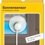 Schellenberg Sonnensensor für RolloDrive 35/45 in gelber Verpackung vor Fenster.