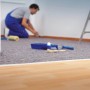 Graues LUX-TOOLS Abdeckvlies schützt Boden bei Streicharbeiten. Rutschfestes Schutzvlies mit Aqua-Stop für Renovierung.