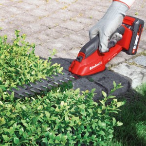 Einhell GC-CG 18 Li Akku-Gras- und Strauchschere beim Schneiden einer Hecke.