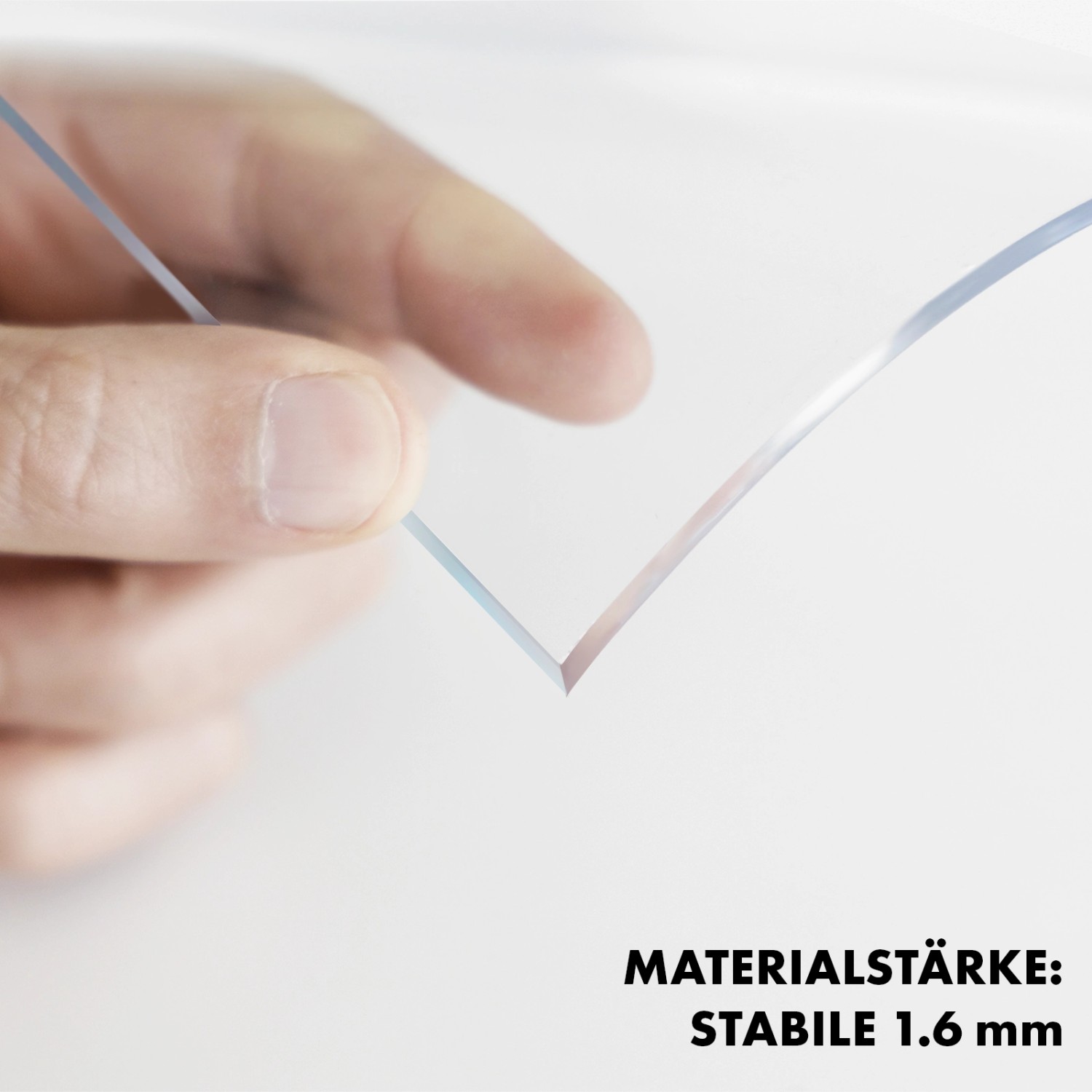 Detailaufnahme einer transparenten KARAT Tischfolie mit abgeschrägter Kante, gehalten in einer Hand.