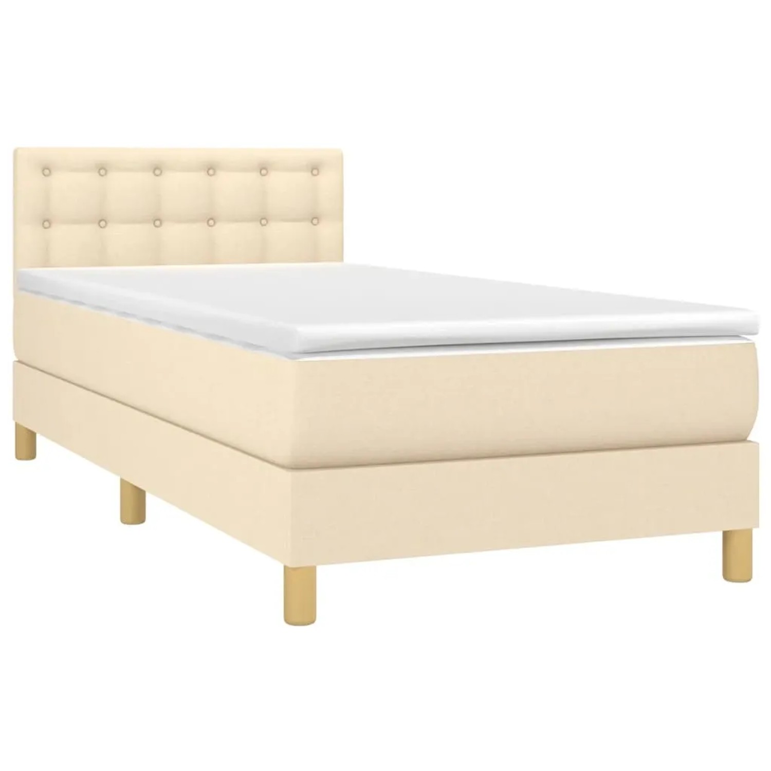 Cremefarbenes Boxspringbett 90x190 cm mit Matratze und Stoffbezug.
