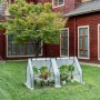 Weißes WOLTU Foliengewächshaus mit Metallrahmen und Fenstern, 180x90x90 cm, im Garten.