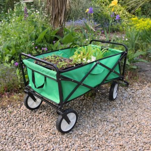 Grüner Monstershop Faltbarer Gartenwagen mit Pflanzen im Garten.