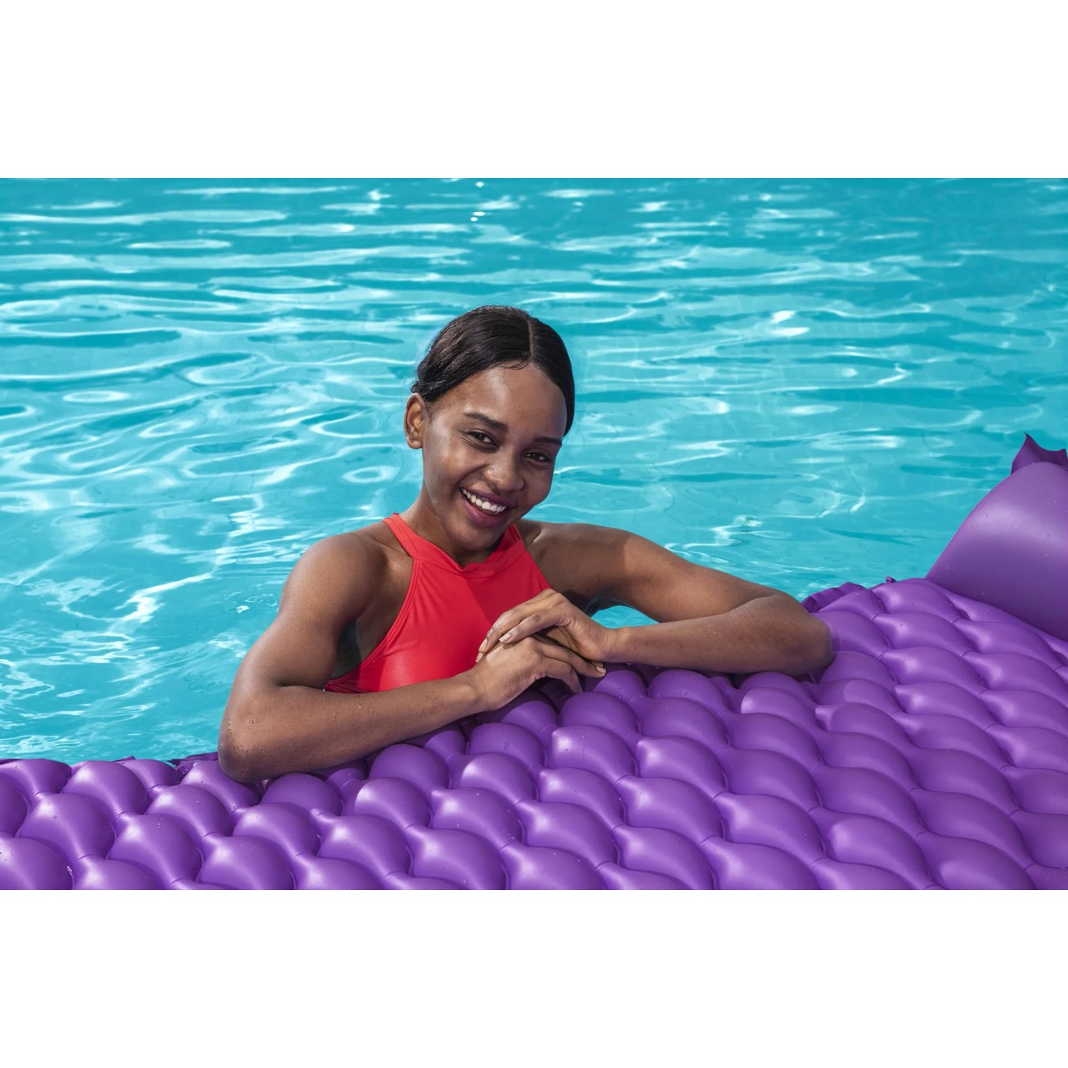 Frau entspannt auf lila Bestway Luftmatratze Float'n Roll im Pool.