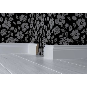 Weiße Sockelleiste White&Black Stil (70x18x2500mm) vor floral gemusterter Wand auf hellem Holzboden.