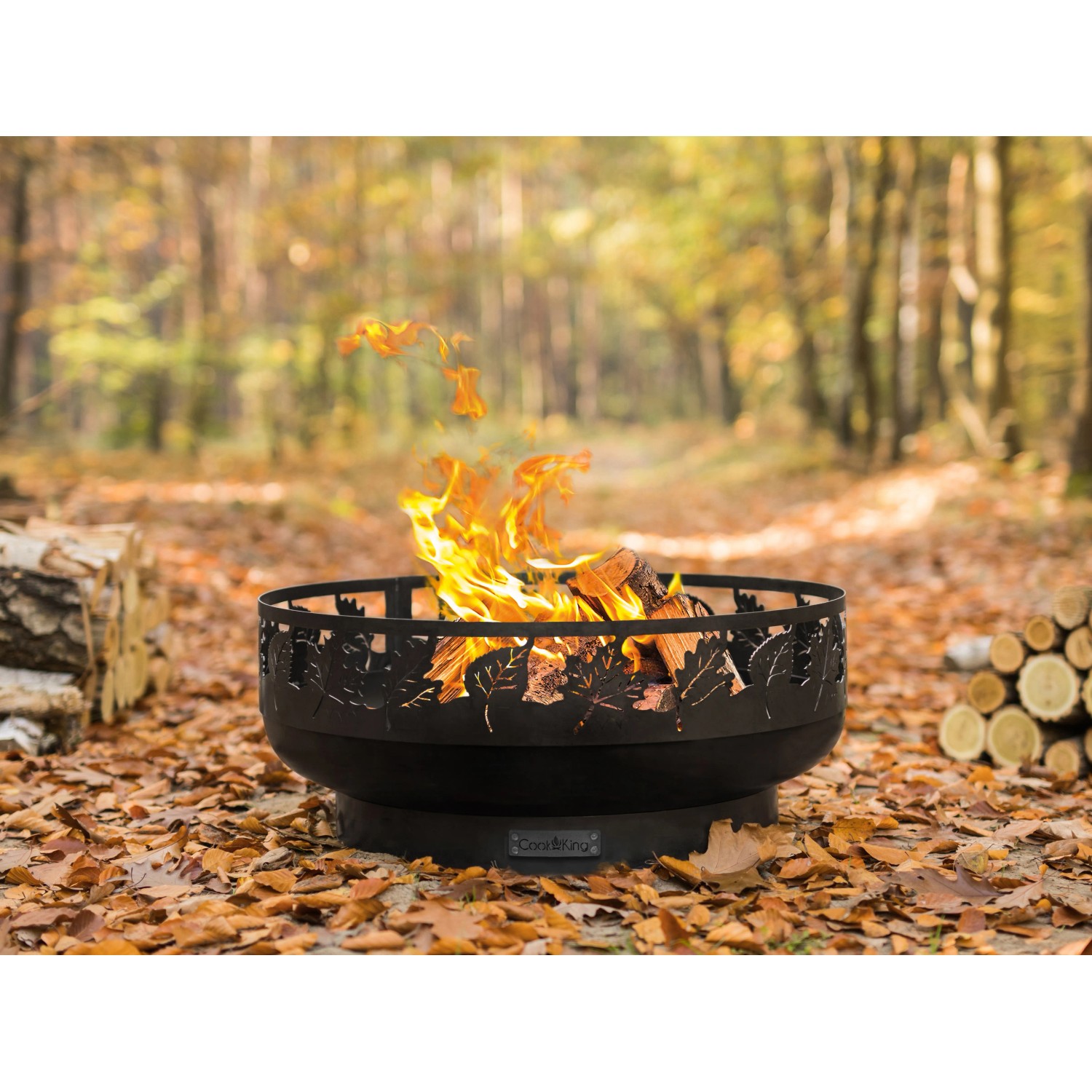 Schwarze CookKing Feuerschale Toronto Ø 80 cm mit Flammen und Blattmuster im Garten.