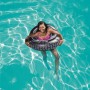 Frau im Wasser mit Bestway® Schwimmring Mud Master im Autoreifen-Design.