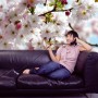 Komar Fototapete Spring mit Frau auf Sofa vor blühenden Kirschbaum, 368x254 cm.