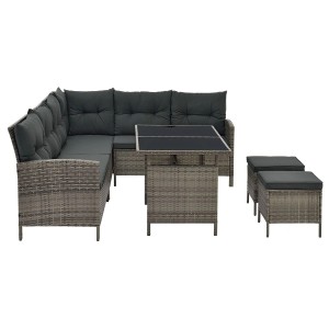 Graue Polyrattan Gartenlounge Manacor mit dunkelgrauen Bezügen, Tisch und Hockern.