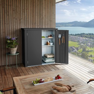 Dunkelgrauer Biohort Terrassenschrank Romeo Gr. M mit geöffneter Tür auf einer Terrasse.