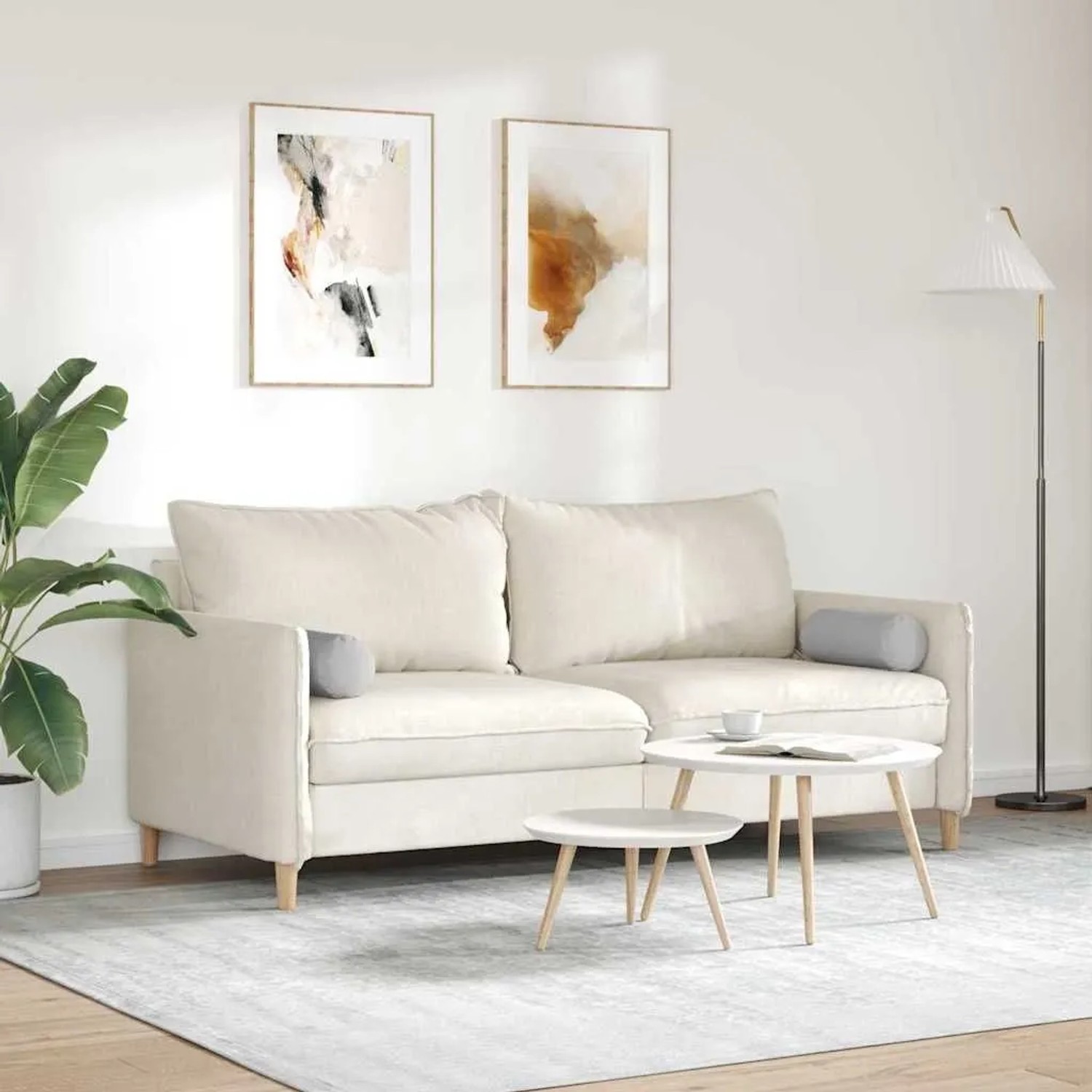 Zwei wolkenfarbene vidaXL Bolsterkissen (Ø 15x40 cm) aus Stoff auf einem Sofa.