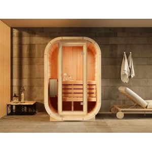 FinnTherm Innensauna Ellipso S: Ovale Massivholzsauna mit Glastür und Liege im Innenraum.