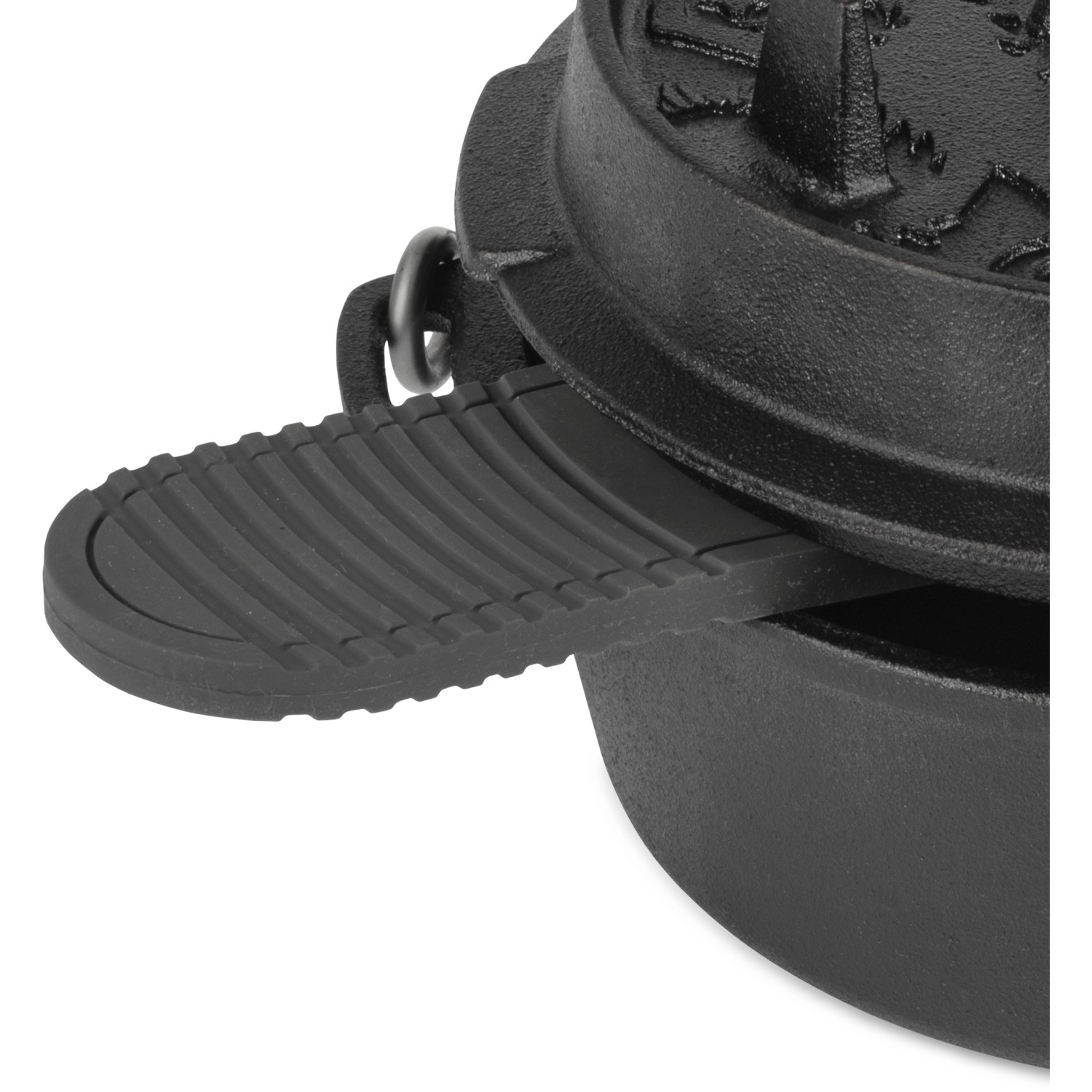 Schwarzer Petromax Silikonuntersetzer zwischen Deckel und Topf eines Dutch Ovens.