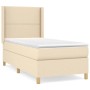 Cremefarbenes Boxspringbett 90x190 cm mit Matratze und Kopfteil. Stoffbezug.