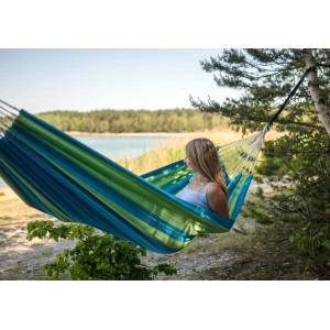 Frau entspannt in grüner Amazonas Hängematte Santana im Garten.