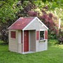 Wendi Toys Kinderspielhaus Krokodil mit rotem Dach, Tür und Fensterläden im Garten.