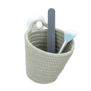 Wenko Aufbewahrungskorb Soria lindgrün mit Nagelfeile und Pinsel, hängend.