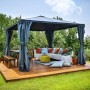 Canopia Gartenpavillon Palermo 3.6 x 3.6 Anthrazit mit Vorhängen und Gartenmöbeln auf Holzterrasse.