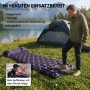 Mann bläst Evocamp Isomatte mit integrierter Fußpumpe auf. Dunkelblaue Camping-Luftmatratze mit Kissen am See.