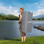 Frau trägt Bestway SUP Board-Set Aqua Drifter im Rucksack zum See.