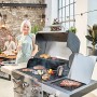 Char-Broil Gasgrill Professional Pro S 3 mit Grillgut und Personen im Garten.