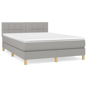 Helles Boxspringbett 140x200 cm mit Matratze und Kopfteil, Stoffbezug.