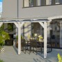 Weiße Skan Holz Terrassenüberdachung Bormio aus Leimholz mit Polycarbonat-Dach und Aufschraubstützen.
