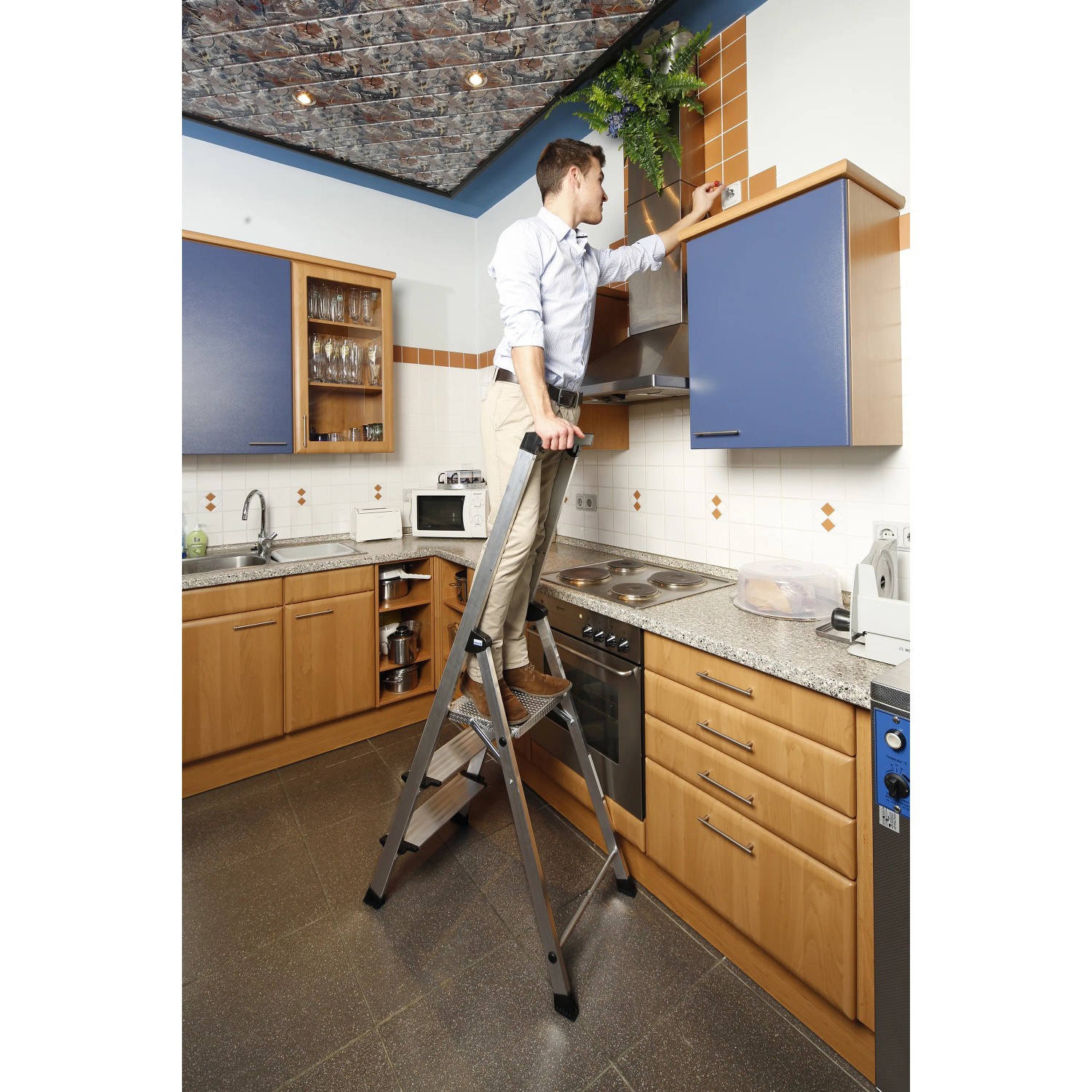 Krause Safety Plusline Stehleiter mit 3 Stufen im Einsatz in einer Küche.