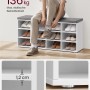 Weiße Vasagle Schuhbank mit grauem Sitzkissen, beladen mit Schuhen und einer Person.