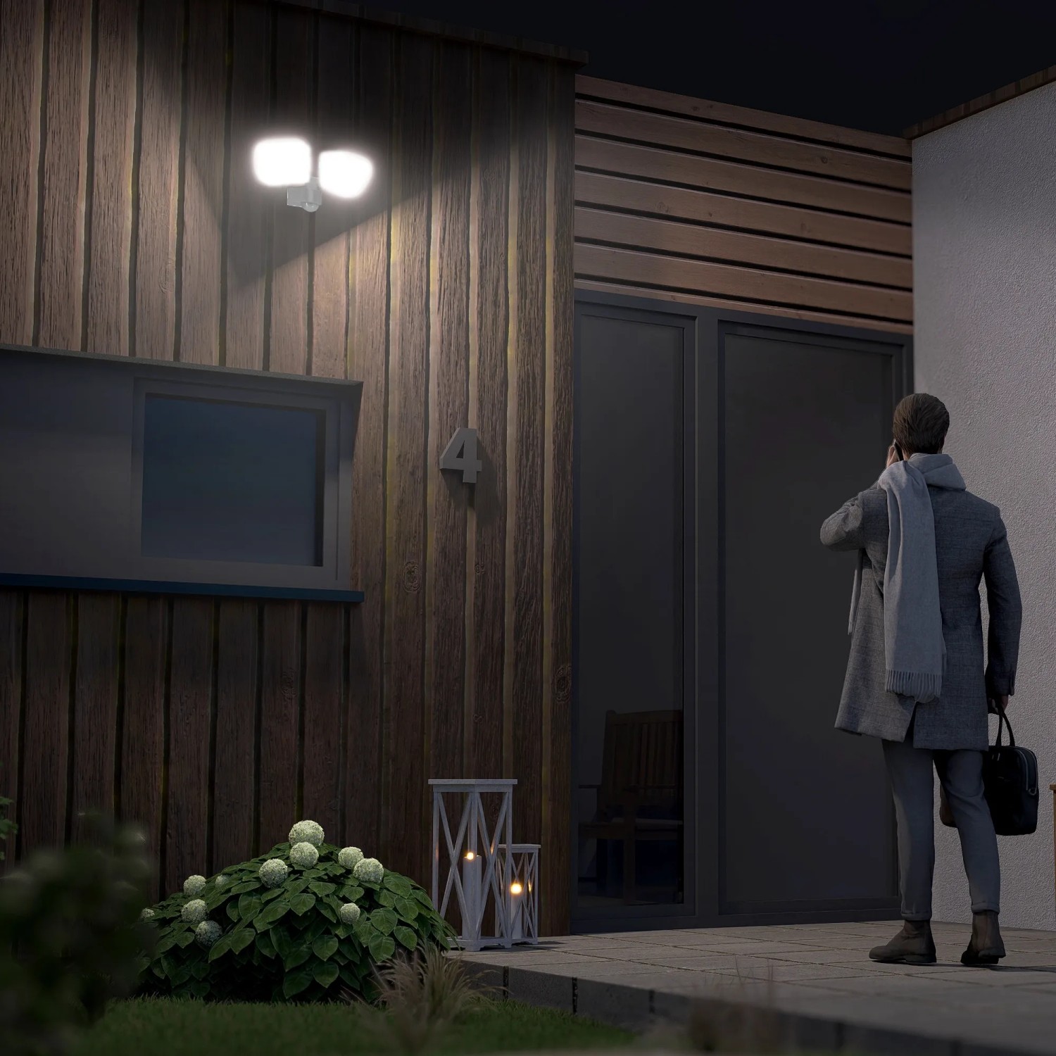 SSC-LUXon NORSU LED Außenstrahler mit Bewegungsmelder, Doppelkopf, neutralweiß leuchtend an Hauswand.
