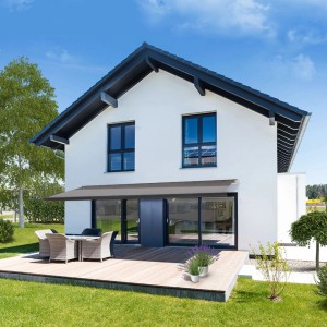 Anthrazitfarbene Home Deluxe Vollkassettenmarkise ELOS 500x300 cm am Haus mit Terrasse.