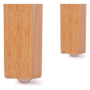 Detailaufnahme: Helle Holzbeine des MCW Esszimmerstuhls Littau Creme mit Bodenschonern.