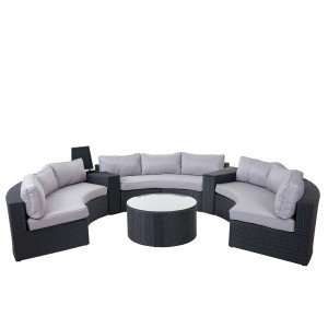 Anthrazitfarbene Poly-Rattan Lounge-Garnitur Savoie mit grauen Kissen und rundem Tisch für 9 Personen.