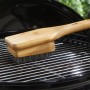 Weber Grillbürste mit Bambusgriff reinigt einen Grillrost. Grillreiniger mit Edelstahlborsten.