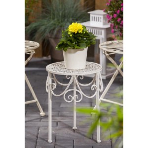 Gelbe Dahlie 'Dahlietta Margaret' im Topf auf einem dekorativen Beistelltisch.