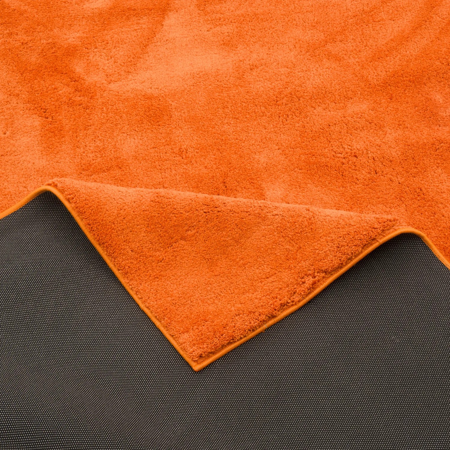 Orangefarbener Hochflor Teppich (120x170cm) mit weicher Textur. Luxus Super Soft Langflor Teppich.