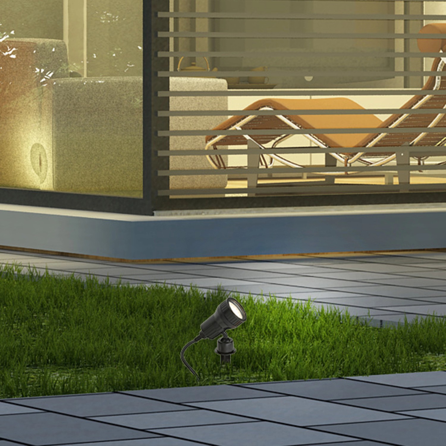 Schwarzer Briloner LED-Gartenspot Terra mit Erdspieß im Rasen vor modernem Haus.