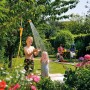 Hozelock Flexi Spray Gartenbrause als Gartendusche im Einsatz mit spielenden Kindern.