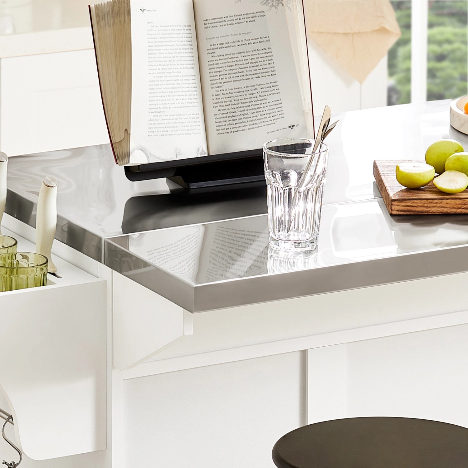 Detailansicht: Küchenwagen FKW41-ST mit Edelstahlplatte, Buch und Glas auf der Arbeitsfläche.