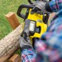 Gelbe Kärcher Akku-Kettensäge CNS 18-30 Battery im Einsatz beim Sägen von Holz.