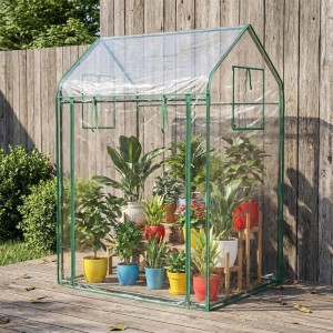 Costway Tomatengewächshaus (129x80x173cm) mit Sonnenschutznetz und Tür, gefüllt mit Pflanzen.