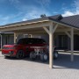 Holzbrüder Doppelcarport Ralf, naturbelassen mit dunkelgrauem Blechdach, unter dem ein Auto und Quad stehen.
