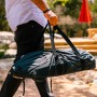 Person trägt Ooni Koda 12 in schwarzer Transporttasche. Grillutensil für einfachen Transport.