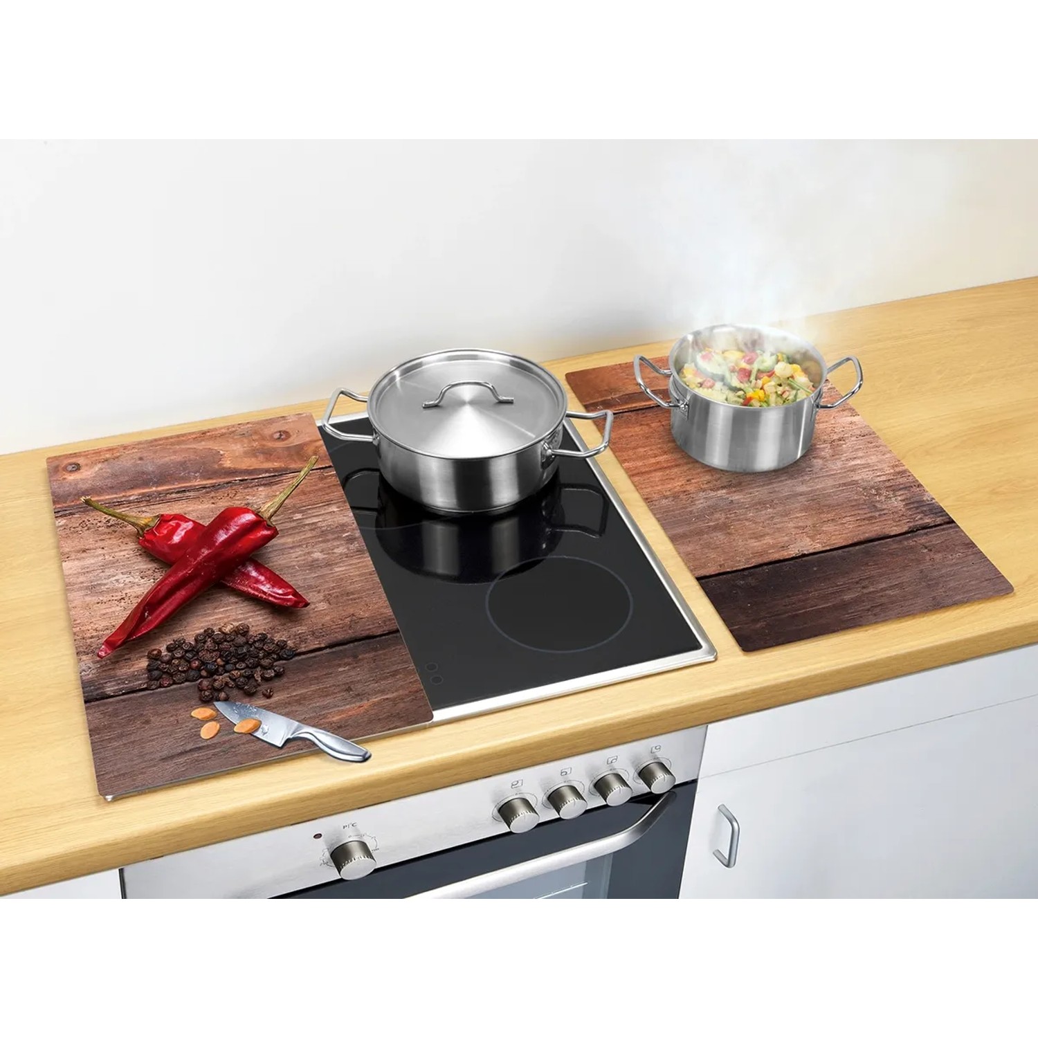 2er-Set Glasabdeckplatten "Pepper" für Glaskeramik-Kochfelder mit Chili-Motiv als Spritzschutz.
