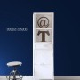 Sanders & Sanders Uni Vliestapete in Marineblau an einer Wand, davor ein weißer Schrank und Hocker. Moderne Wandgestaltung.