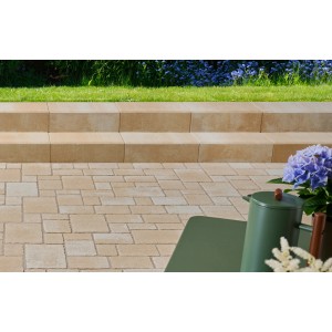 Kann Blockstufe Sandsteingelb-Nuanciert im Garten, mit passenden Pflastersteinen und blauen Blumen.
