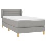 Hellgraues Boxspringbett 100x200 cm mit Matratze und Kopfteil.