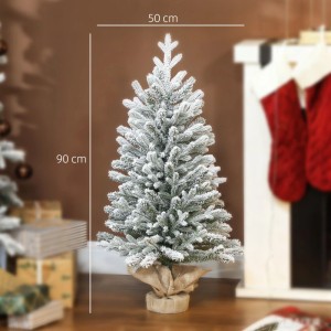 Verschneiter künstlicher Weihnachtsbaum, 90 cm hoch, mit grünen Zweigen und Leinenfuß. Festliche Weihnachtsdekoration.