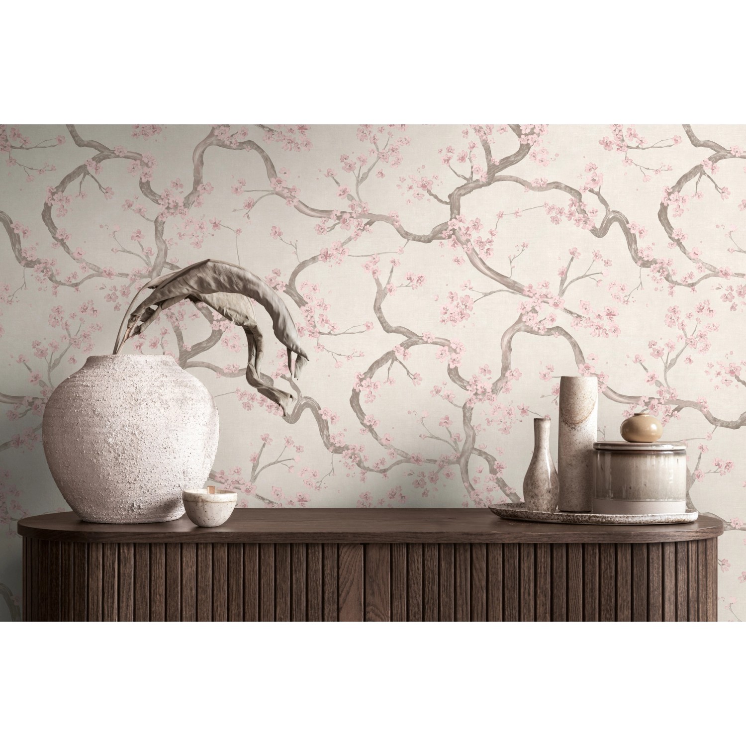 A.S. Creation Vliestapete Blütenmuster in Creme-Rosa an Wand hinter Kommode mit Deko.
